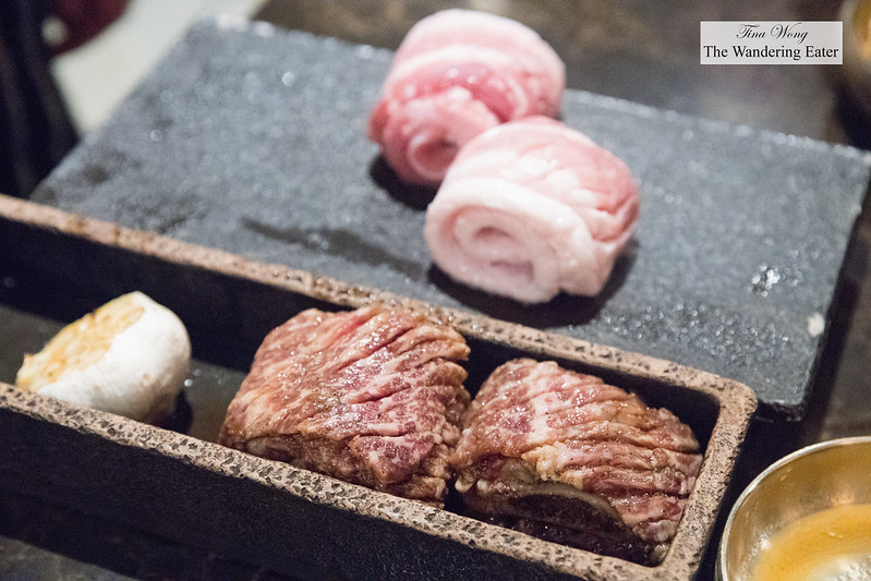 Samwon Galbi (namesake marinated beef short rib) and raw head of garlic and pork belly