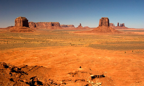 Monument Valley, a flat sandy desert filled sandstone buttes and pinnacles, within the Navajo Indian Reservation straddling the border lands of Arizona and Utah in the American Southwest
