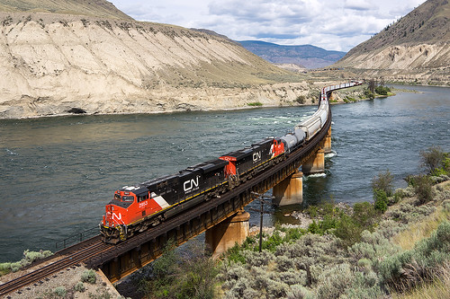 canada canadian national ashcroft british columbia train river water bridge long hill mountain steel car coach locomotive engine