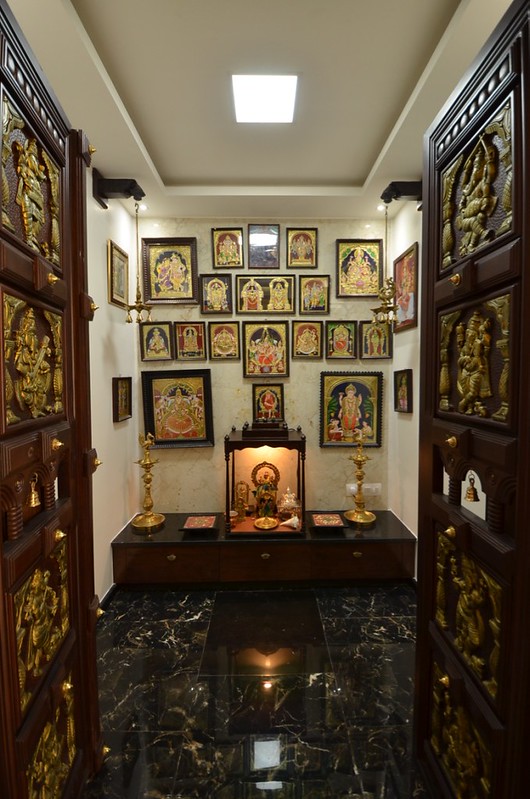 pooja room with carved wooden door