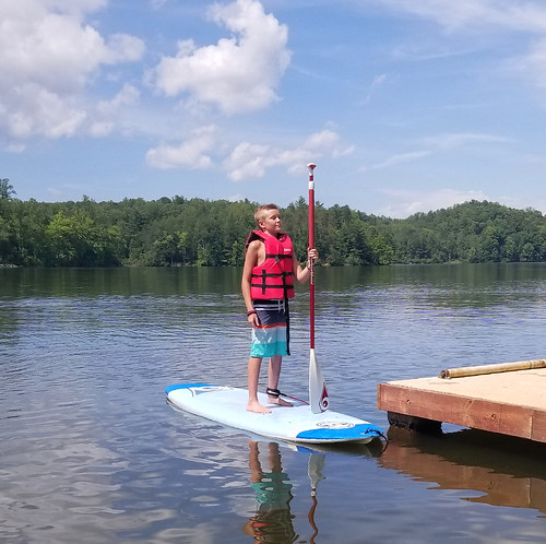 boy sup lake paddlboard lifejacket paddle