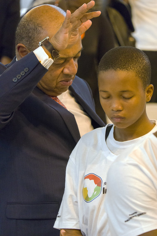Passing on the anointing. Lord Boeteng praying for the youth of Africa. Picture by Bible Society, Andrew Boyd