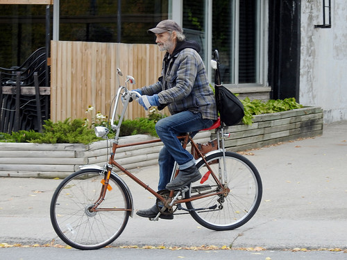 A fellow riding a customized or facsimile banana bike in Smiths Falls, Ontario