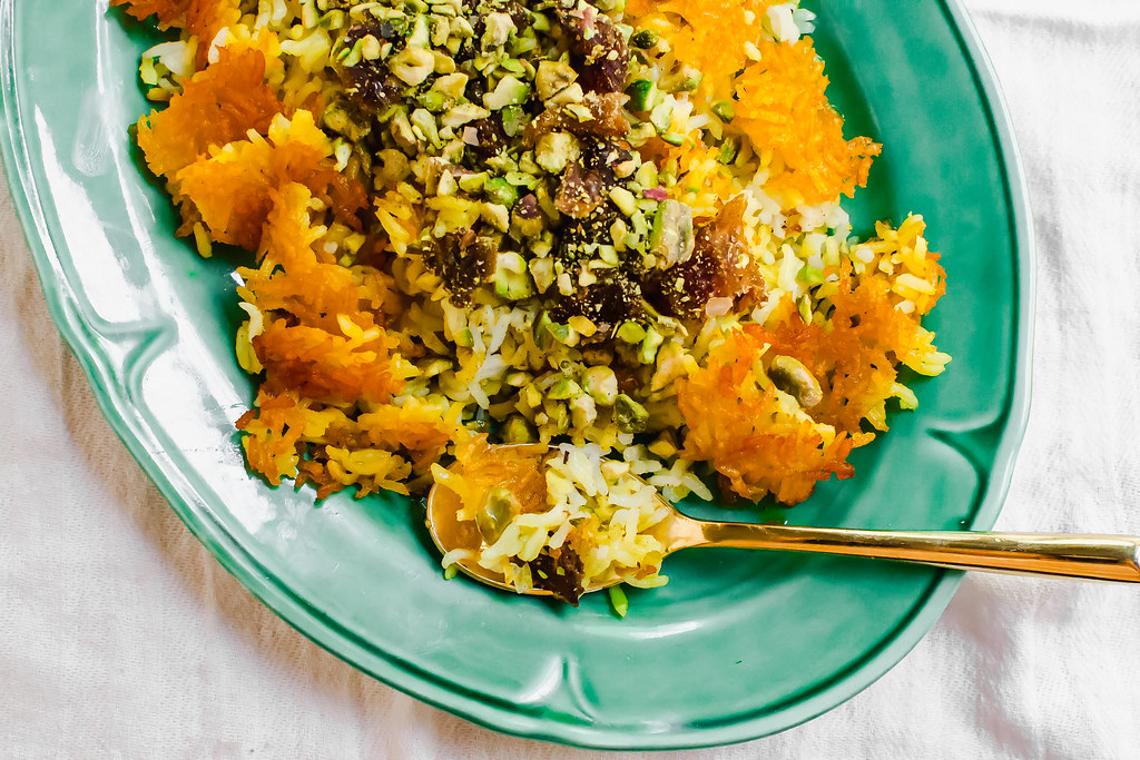 Persian rice with dates, chopped pistachios and aromatic cardamom is steamed together with an additive and crunchy saffron crust called tahdig.
