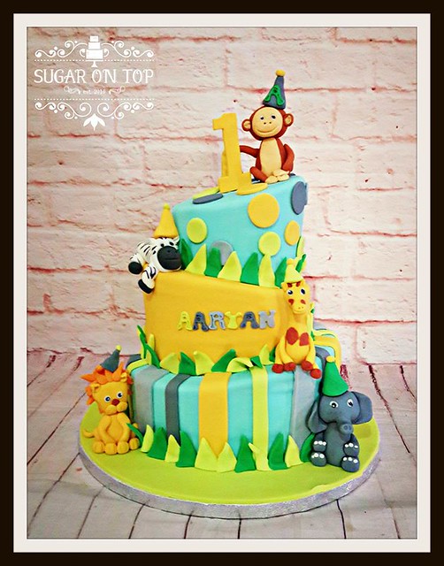 Colourful Topsy Turvy 3 Tier Cake with Sugar Animals by Sugar on Top