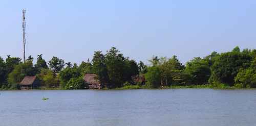 hochiminh city saigon river sky water shore vegetation vietnam hut