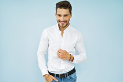 Cheerful smiling young male model in white shirt