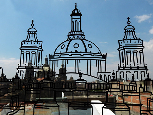 Windows in Mexico City's Spanish Cultural Centre are painted with line drawings of the buildings off in the distance, in this case a view of the cathedral