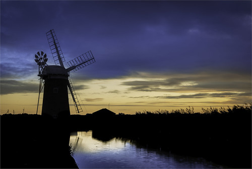 wind windmill pump sunset sky landscape silhouette rural old water mill sunrise farming cloud vintage nature sun orange technology power twilight country dusk turbine machine tower environment countryside traditional horizon outdoor antique black evening blue glow color nostalgia windpump clouds peaceful scenic orangesky tranquil sundown silhouetted