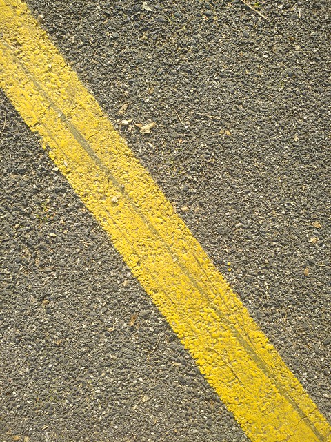 Asphalt texture with yellow sign