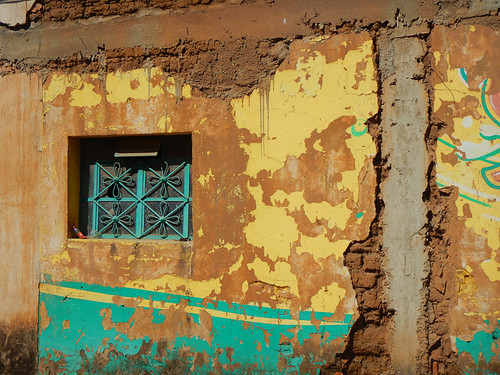 A barred window in a colourful wall in Mascota, Mexico