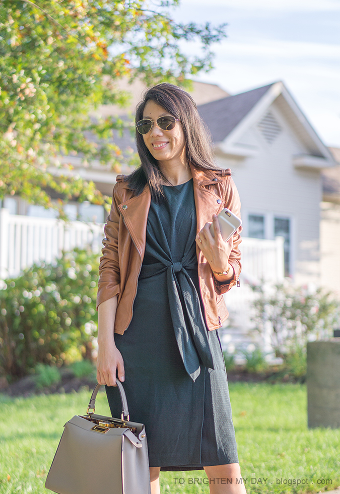 cognac brown leather jacket, dark green tie front dress, gold watch, taupe bag