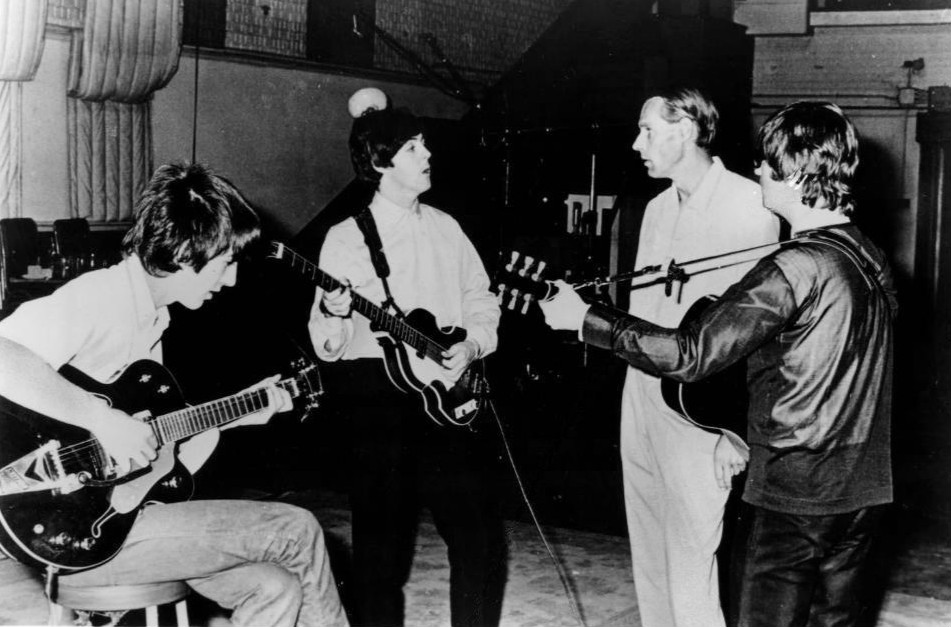 Publicity photo of the Beatles with producer George Martin in the studio at Abbey Road. Only John Lennon, George Harrison and Paul McCartney are pictured.