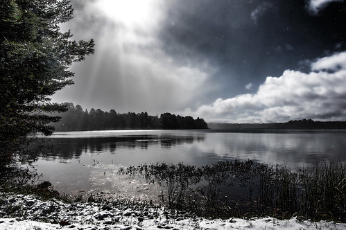 lake water sky sun sunrays forest deerskinlake eagleriverwisconsin eagleriver wisconsin snow clouds