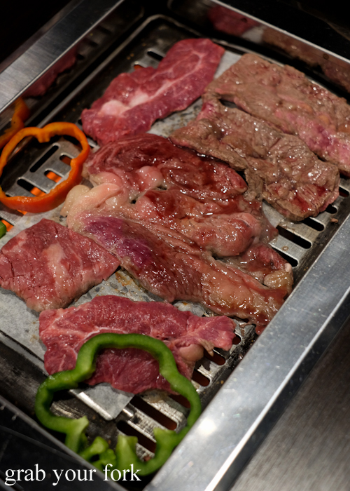 Angus beef and wagyu steaks on the barbecue grill at all you can eat Korean bbq Se Jong in the Sydney CBD