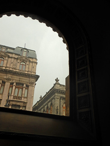 A view of old buildings from a decorative arched window of the Palacio Postal (Main Post Office) in Mexico City