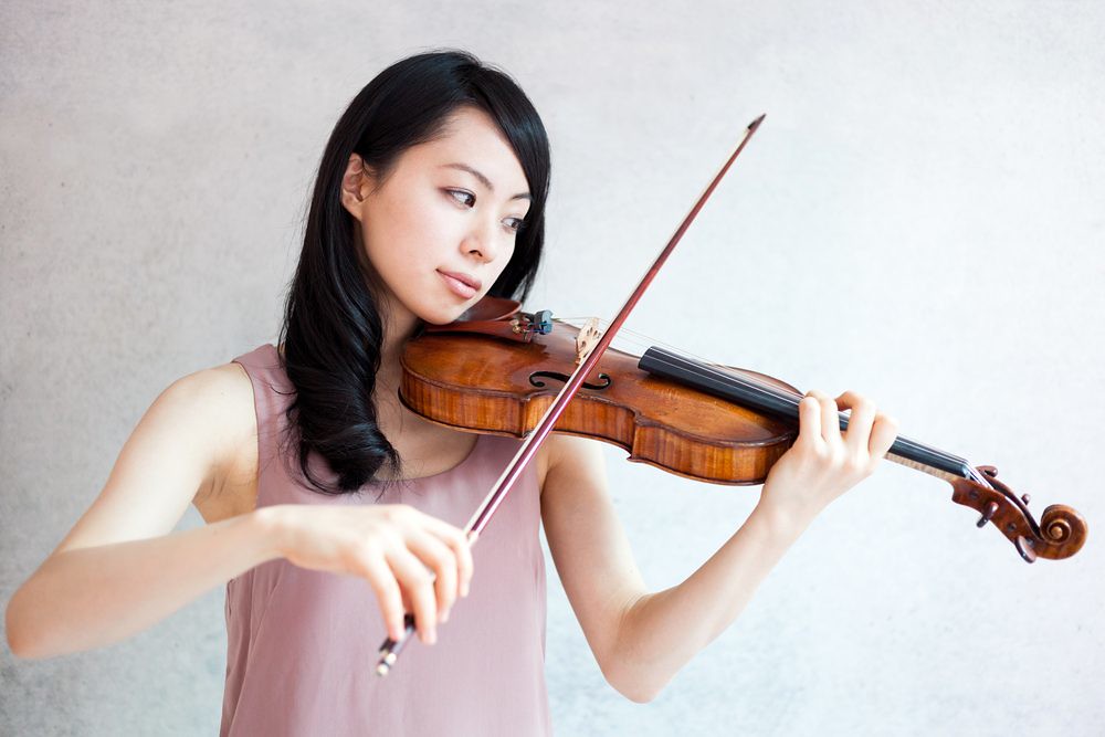 violinist playing with focused look on her face