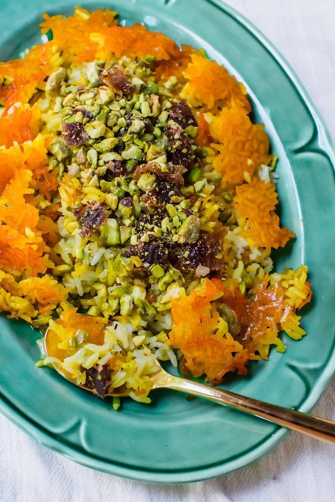 Persian rice with dates, chopped pistachios and aromatic cardamom is steamed together with an additive and crunchy saffron crust called tahdig.