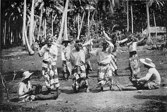 Tahitians wearing the pareo wrap-around garment and practicing a 'upa'upa dance, circa 1909. From 'Mystic Isles of the South Seas' by Frederick Brown.